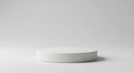 A simple, pristine white cylindrical pedestal on a seamless light grey background with soft, even lighting. Ideal for clean product presentations and minimalist displays.の素材