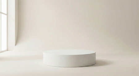 A clean, white cylindrical display stand positioned in a bright, minimalist studio space. Natural light streams from a large window, casting soft shadows and highlighting the serene ambiance.の素材