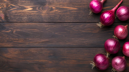 Deep red onions with striking purple hues are presented on a textured, dark wooden background. The image captures the rich color and texture of these flavorful vegetables.の素材