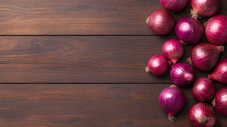 A collection of vibrant red onions artfully arranged on a rustic dark wooden table.の素材
