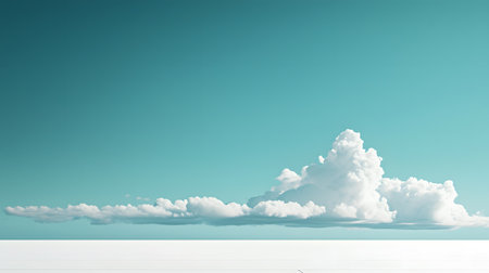 A vast expanse of tranquil turquoise sky meets a lowlying line of fluffy cumulus clouds.の素材