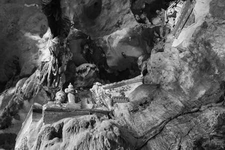 Chiang dao cave wall with antique statue in black and white style