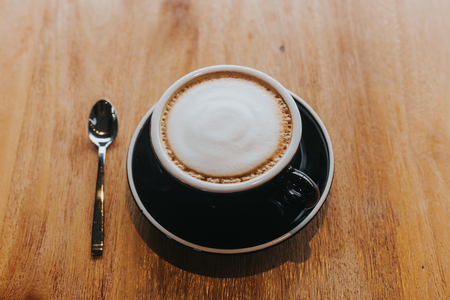 hot coffee in black cup on wooden table.の写真素材