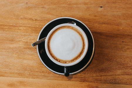 hot coffee in black cup on wooden table.の写真素材