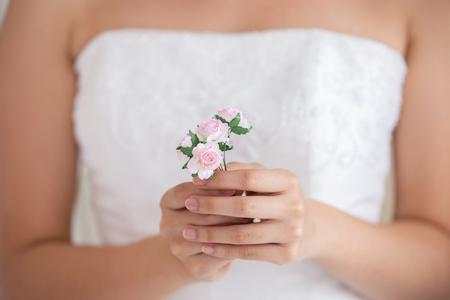Beautiful wedding small bouquet in hands of the bride.の写真素材