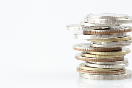 Piles of coins with copy space on white background.の写真素材