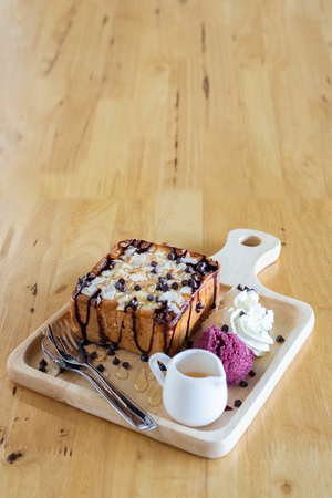 honey toasts in wood dish on wooden table.の写真素材
