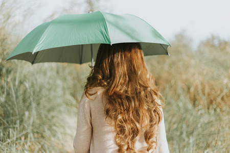 girl in dress hold green umbrellaの写真素材