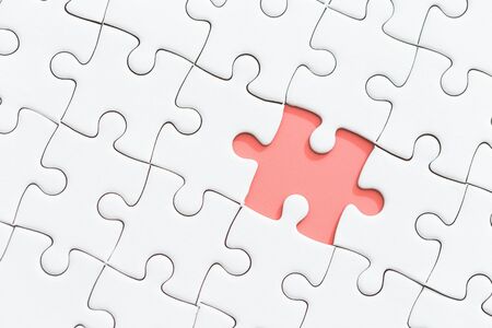 white jigsaw puzzle with missing piece.の写真素材