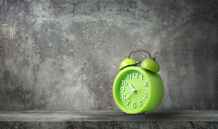Green analog alarm clock dark background vintage grunge style and copy space.の写真素材