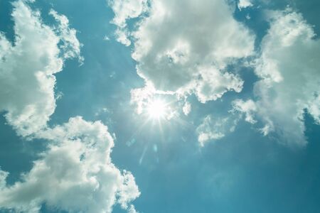 pure blue sky with white clouds and flare sunlight. summer skies and the sun shines.の写真素材