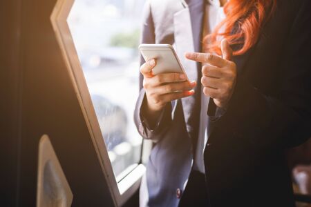 close up smartphone in hand business woman, business concept.の写真素材