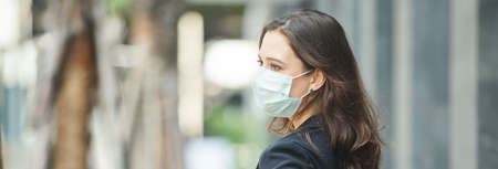 close up face woman wearing medical mask prevent infection virus in coronavirus covid 19 pandemic, copy space.の写真素材