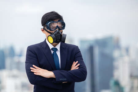 architect man wear black suit and yellow helmet view from back standing on building looking for cityscape. looking for future concept.の写真素材