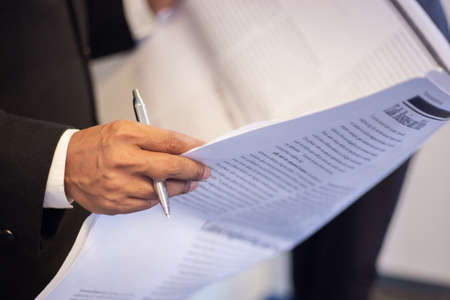 business man writes a handle on sheets of paper