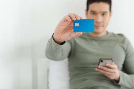 Close up of blank blue smart card in man hand. man holding blue smart card.