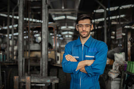 portrait image engineer men wearing uniform safety in factory background.