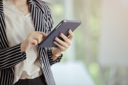 close up hand of businesswoman using tablet working in office, Find business information online, Start up partners and business concept.の写真素材