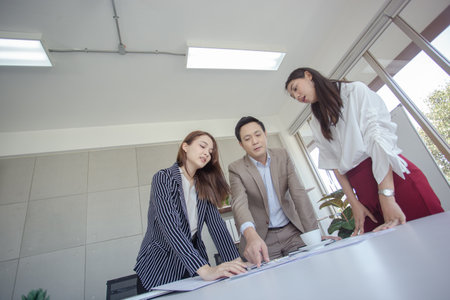 Asian business team standing brainstorm ideas presentation for a new project. Teamwork meeting...