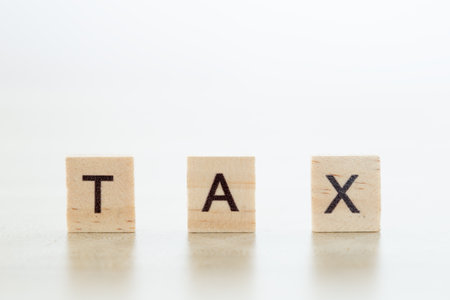 wooden block with word tax, pay and debt, business and finance concept.