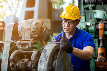 Man Industry wearing helmet safety working repair machine in factory.の写真素材