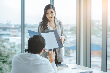 Asian business woman presentation work for customer in meeting room office.の写真素材