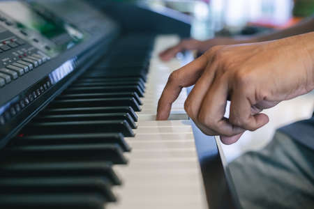 Hand of man play piano keyboard, Music concept.