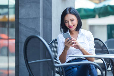 Young woman using smartphone work online in cafe,copy space.