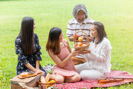 asian happy family picnic in garden.の写真素材