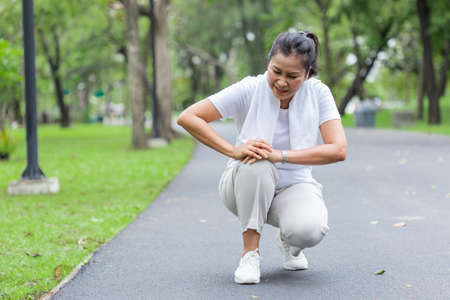 Elderly women accident from exercise. knee acheの写真素材