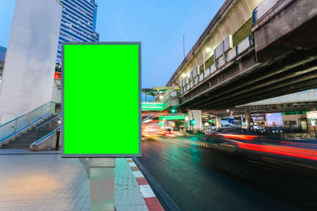 Blank billboard with green screen traffic city road long exposure background, copy space for your text on a street.の写真素材