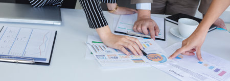 Business team brainstorm ideas presentation for a new project with chart document on office table,...