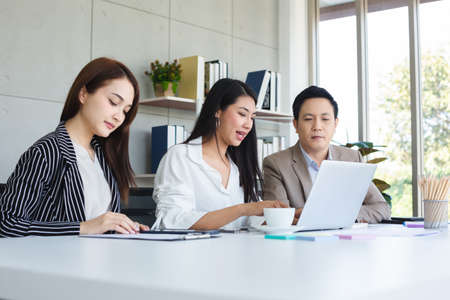 Asian business team brainstorm ideas presentation working with laptop at table office. Teamwork planning concept.の写真素材