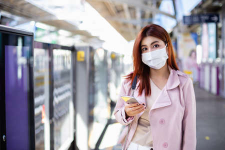 asian beautiful woman wearing medical mask for prevent dust and infection virusà¸¡ standing in...