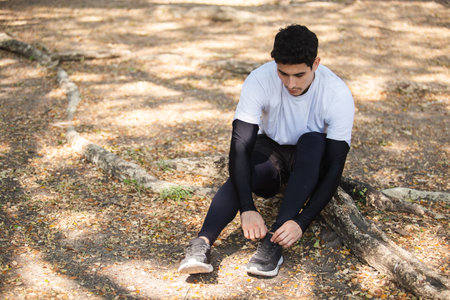 Man tied up shoes on stairs after running exercise in garden.の写真素材