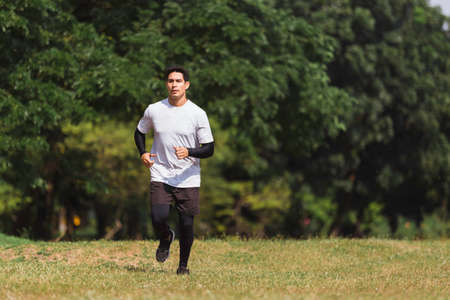 man running exercise in green park morning time.の写真素材