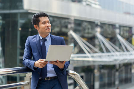 asian businessman portrait with laptop.の写真素材