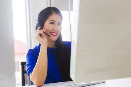 woman operators with microphone and computer at work, Call center, support telemarketing.の写真素材