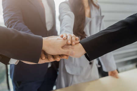 Close up business people connect joining hands together, Stack of hands, Teamwork partner concept.