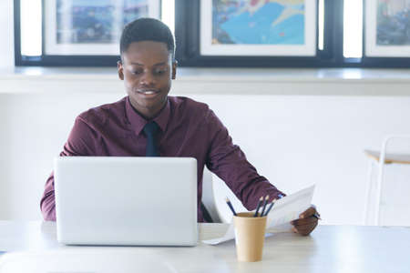 Young businessman handsome African American black skin working on laptop at office. businessperson...