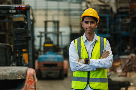 asian man engineering worker wear uniform and helmet in warehouse. workplace factory industrial...
