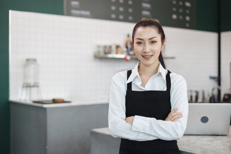 portrait, asian young women barista standing arm crosses at counter receive customer orders in cafe....