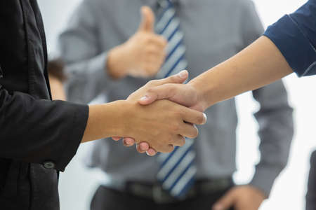 businesspeople shaking hands partnership connection agreement success.の写真素材