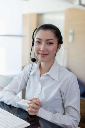 Portrait asian beautiful woman wearing headsets worker call center. Businesswoman advisor call center concept. looking at the camera.の写真素材