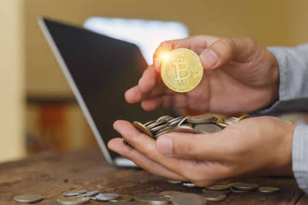 Bitcoin in hand holding businessman. cryptocurrency electronic investment. crypto economy cash.の写真素材