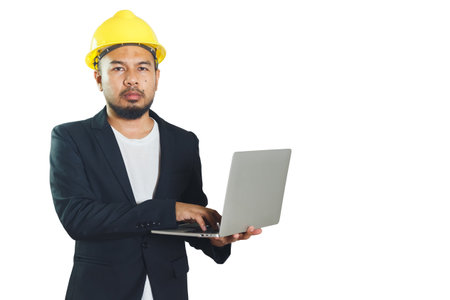 Asian engineering man wears hardhat holding working with laptop isolated on white background. foreman control construction.  .の写真素材