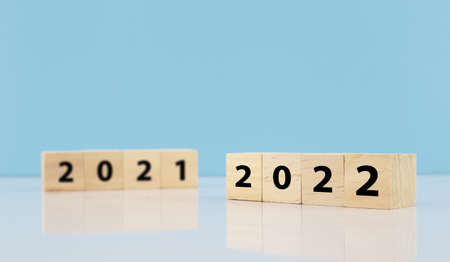woodblocks cubes with a number 2021 change to 2022 blue background. new year 2021- 2022 concept.の写真素材