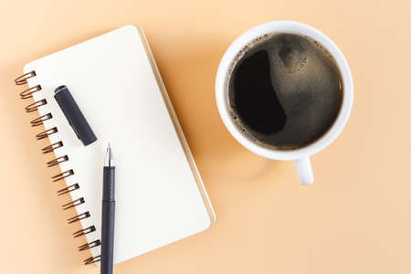 Notebook empty for take notes with pencil and coffee cup on office table. business object. Top view with copy space.の写真素材