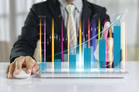 Businessman index finger trading graph using computer keyboard. stock exchange marketing analyzing...