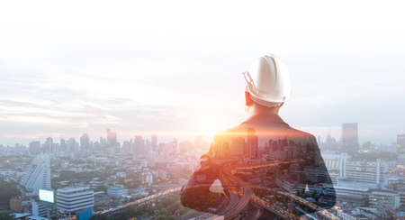 Double exposure image, Man engineer overlay with building architecture urban cityscape. Creation...
